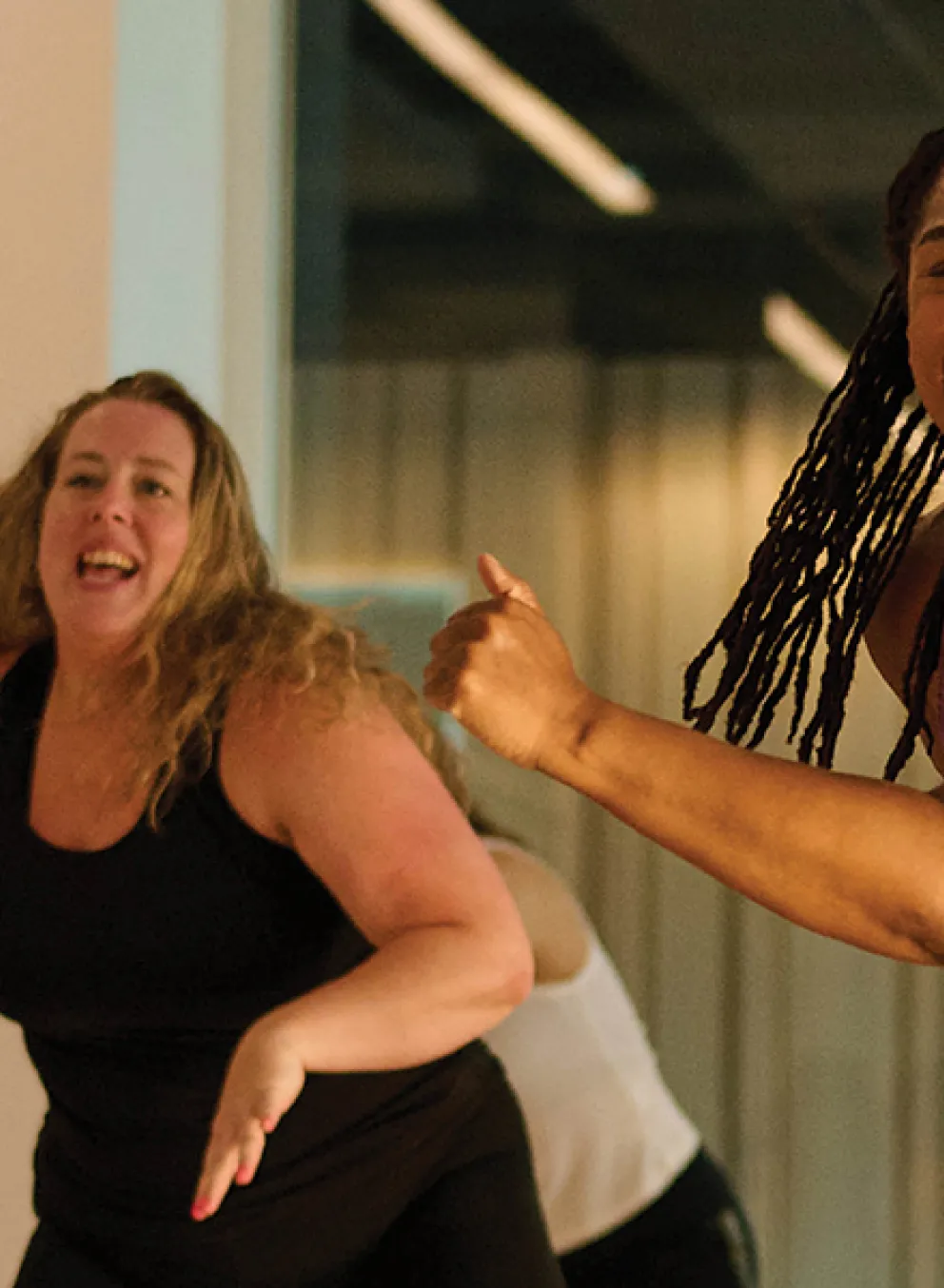 Several women engaged in a dance class, demonstrating different movements and enjoying the rhythm together.